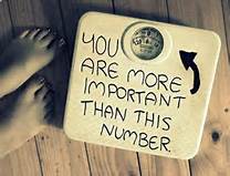 A weight scale with the words "You are more important than this number"