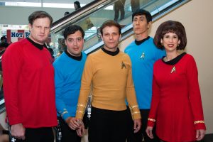 Trekkers dressing up in authentic star trek costumes as seen on the show at a star trek convention