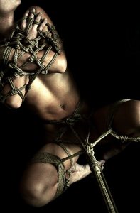photo of a white person tied up using delicate rope work; the image has nothing inappropriate within it