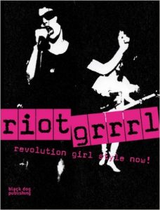 A picture of the book Riot Grrrl: Revolution Girl Style Now! by Nadine Modem. A black and white picture of women singing with sun glasses on with the title of the book in black and pink