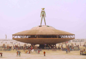 Image of large scale alien and space ship art installation with participants in the background