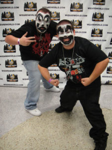 Two juggles in clown makeup.