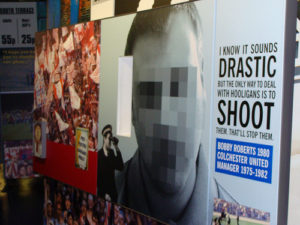 A billboard with a quote from a former coach who believes the only way to end hooliganism is to shoot and kill them all