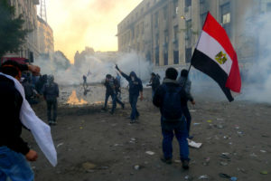 Hooligans are walking in the streets with their faces covered after police have thrown tear gas to try and disperse the rioting crowd.