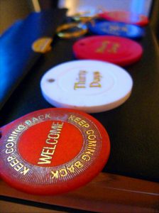 Three Alcoholics Anonymous sobriety coins side by side