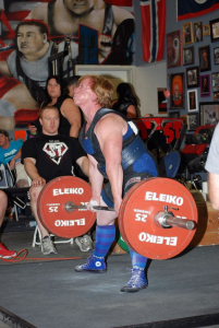 Powerlifter deadlifting a large barbell