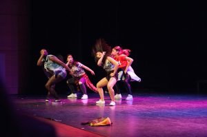 Image of a four person B-girl crew performing on stage