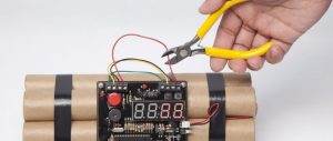 Person using pliers to defuse bomb