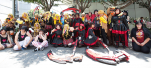 a group of anime fans wearing costumes of their favourite anime characters at an Anime Expo gathering.