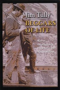 A sepia photo of two men walking down train tracks and both are wearing suits. One is wearing a fedora and one is wearing a conductor hat. Text in the corner reads, "Jim Tully: BEGGARS OF LIFE"