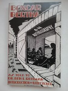 A black and white drawing of the side of an open boxcar. There are silohuettes of women sitting inside. Text reads, "Boxcar Bertha: An Autobiography. As told to Dr. Ben L. Reitman. Introduction by Kathey Acker"