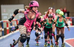 A roller derby skater is shown skating in a bout with other skaters