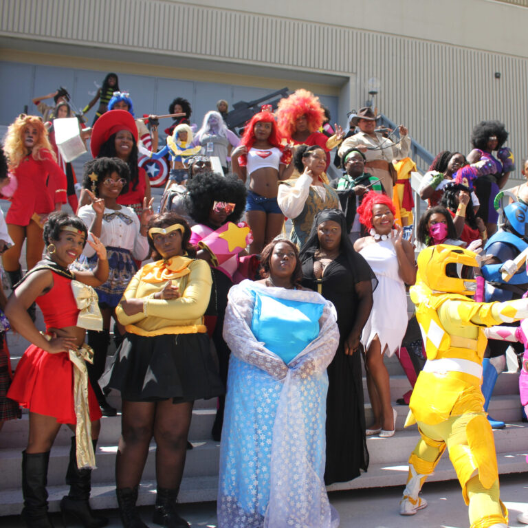 A group of Black geeks in costume takes a picture at the 2017 Dragon Con.