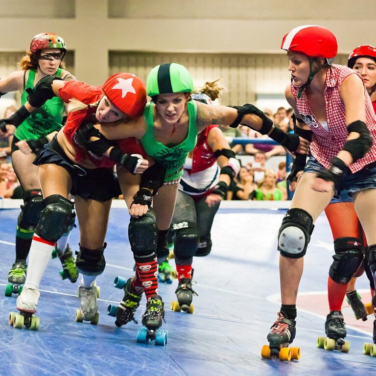 A Roller Derby game between the Cherry Bombs (Green) vs Rhinestone Cowgirls (Red) on Aug 27, 2011, in Austin, Texas. Photo by WikiMedia Commons.